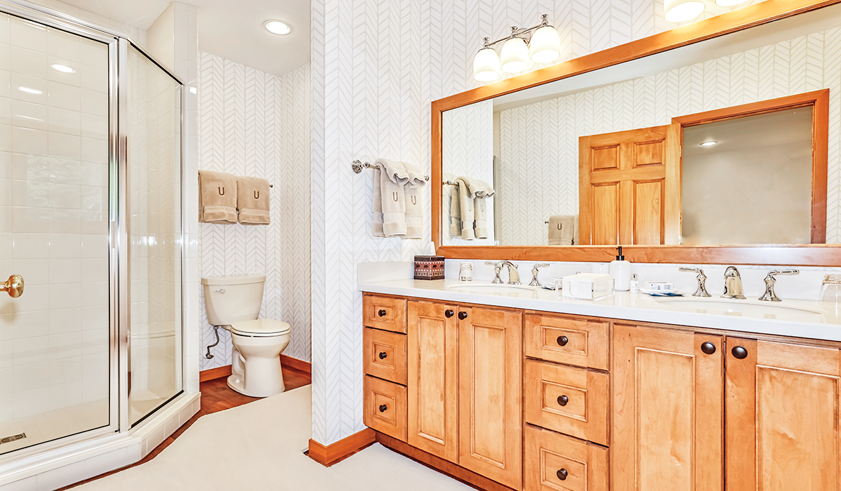 Double-sink bathroom with extra lighting and oversized mirror.